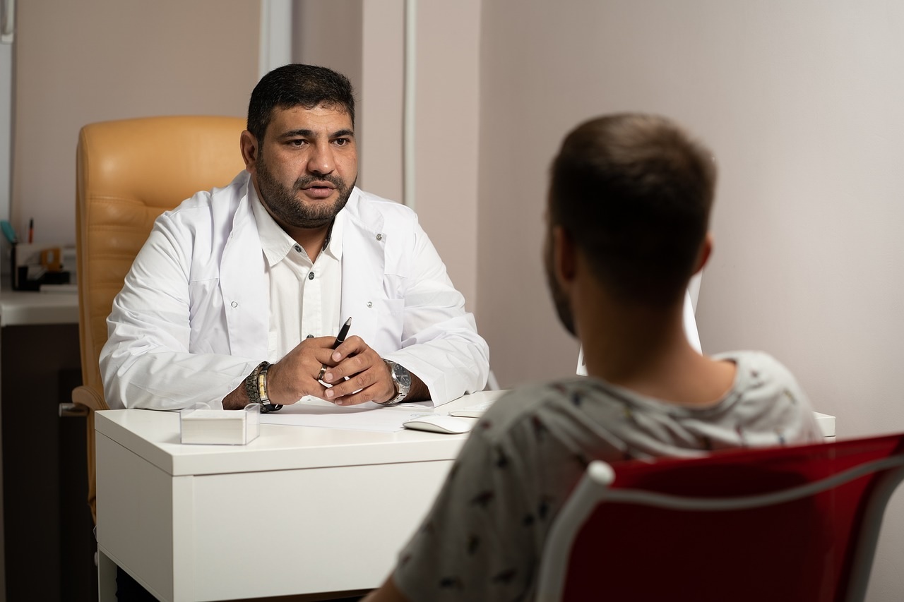 A doctor and a patient discussing in an office.