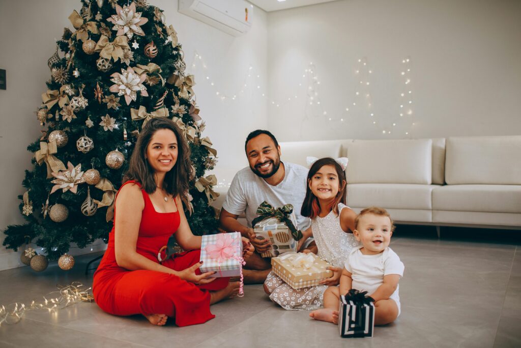 a happy family next to the Christmas tree